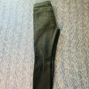 Faded black jeans with one knee rip.
